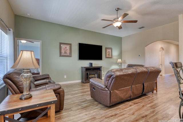 living room featuring ceiling fan and light wood-type flooring