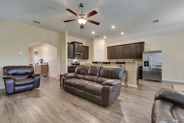 living room featuring ceiling fan and light hardwood / wood-style flooring