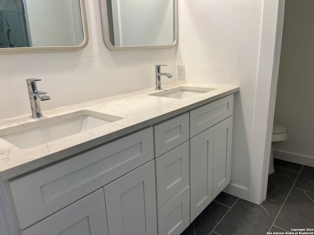 bathroom featuring vanity, toilet, and tile patterned floors