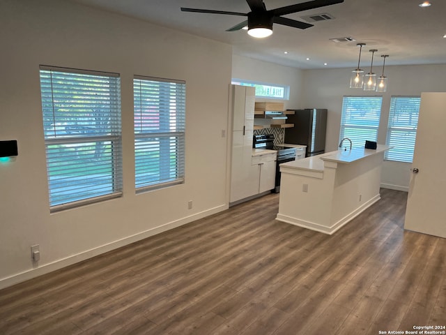 kitchen with hanging light fixtures, electric range oven, dark hardwood / wood-style flooring, and a kitchen island