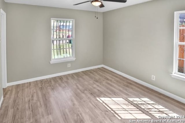 spare room featuring light wood-type flooring and ceiling fan