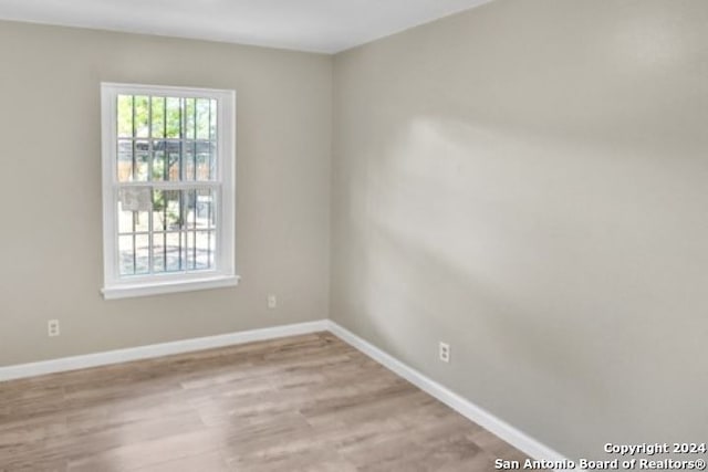 spare room featuring light hardwood / wood-style floors