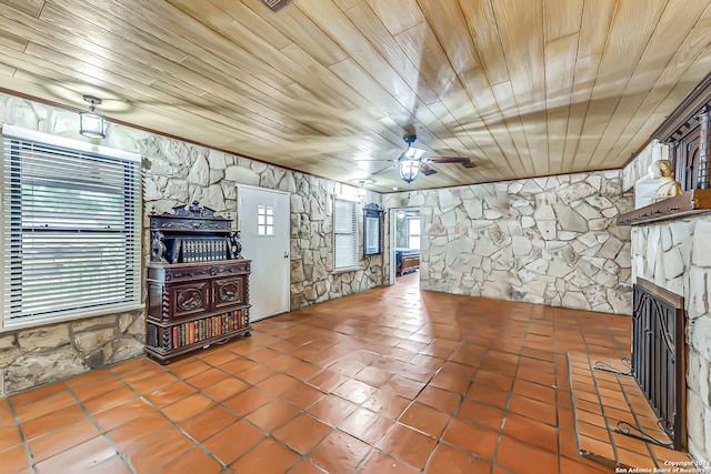 unfurnished living room with a fireplace, tile patterned flooring, ceiling fan, and wooden ceiling