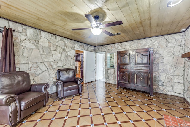 living area featuring tile patterned flooring and wooden ceiling