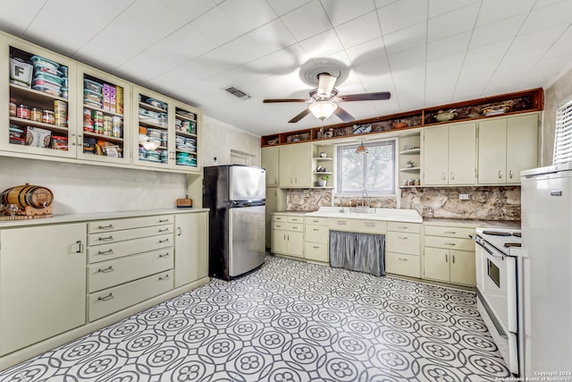 kitchen featuring decorative backsplash, white appliances, and ceiling fan