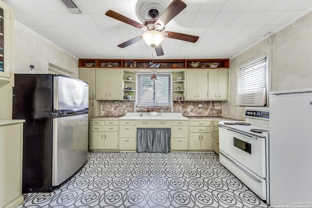 kitchen featuring tasteful backsplash, ceiling fan, cream cabinets, and white appliances