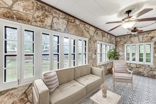 sunroom featuring ceiling fan and a healthy amount of sunlight