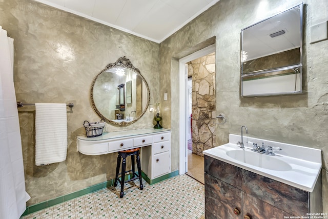 bathroom featuring vanity, tile patterned floors, and crown molding