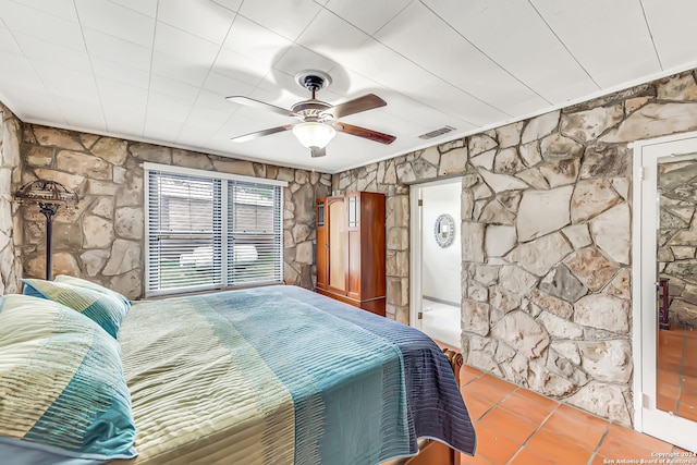 tiled bedroom featuring ceiling fan