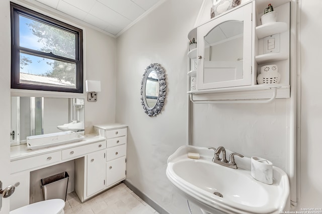 bathroom with crown molding and sink