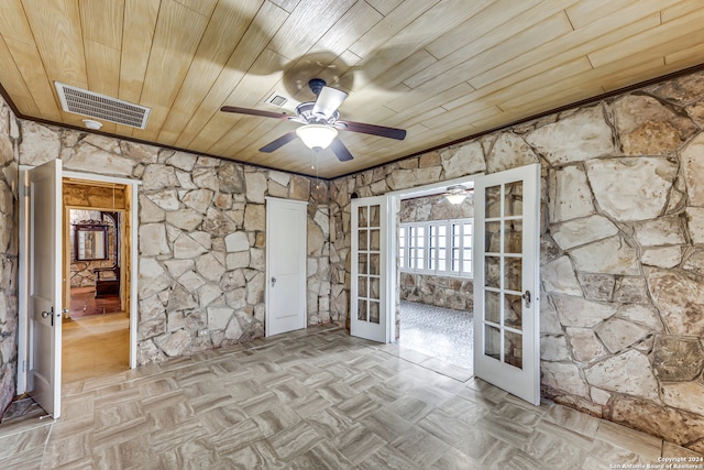 spare room featuring ceiling fan, french doors, and wooden ceiling