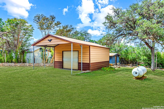 view of outdoor structure featuring a yard and a garage