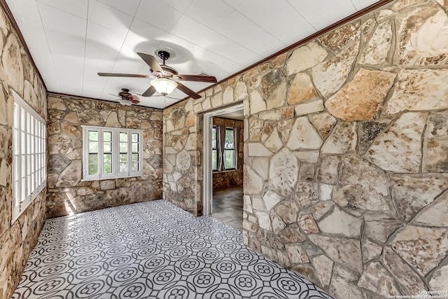 unfurnished room with ceiling fan, a healthy amount of sunlight, and ornamental molding