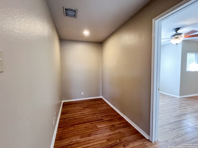 corridor with hardwood / wood-style floors