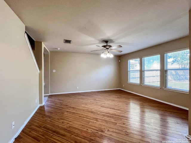 unfurnished room with ceiling fan, a textured ceiling, and hardwood / wood-style floors