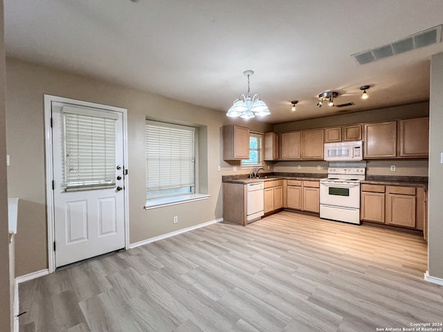 kitchen with light hardwood / wood-style floors, white appliances, pendant lighting, sink, and a notable chandelier