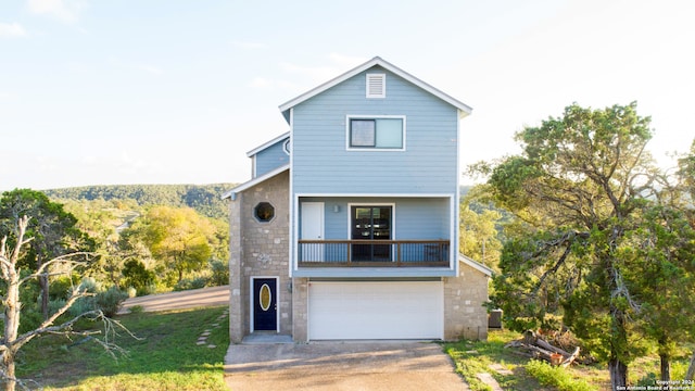 view of front facade with a balcony and a garage