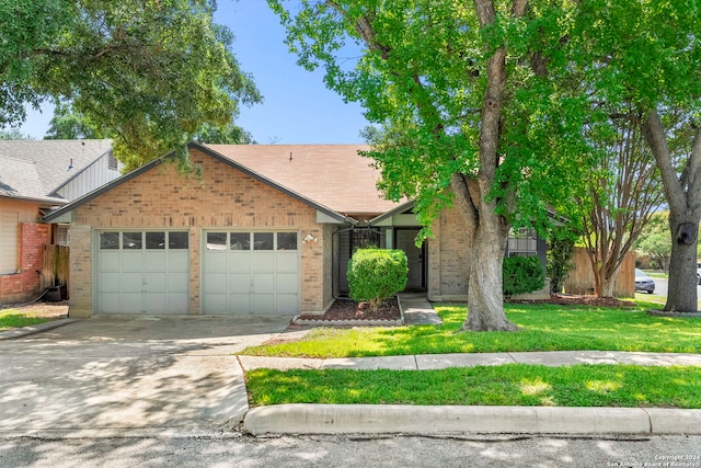 view of front of home featuring a front yard and a garage