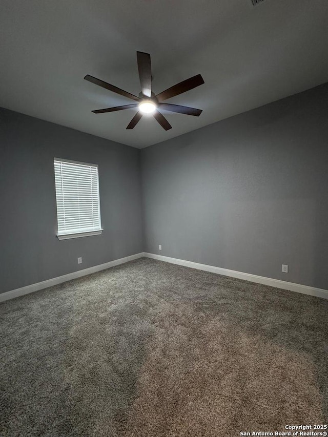 carpeted spare room with ceiling fan