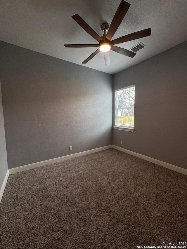 carpeted empty room featuring a textured ceiling and ceiling fan