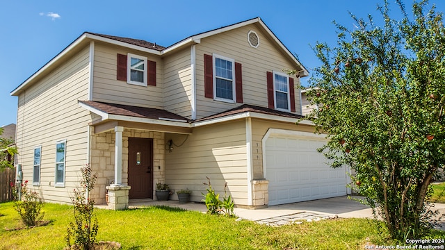 view of front of home with a garage and a front lawn