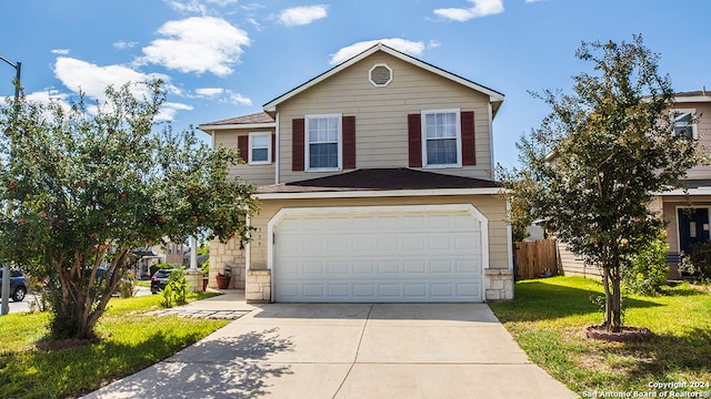 front of property featuring a front yard and a garage