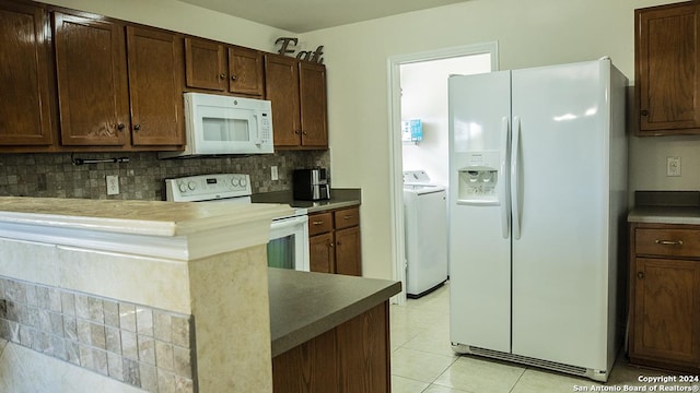339 Cedron Chase, San Antonio, TX 78253 - kitchen with white appliances, tasteful backsplash, washing machine and clothes dryer, light tile patterned floors, and a peninsula