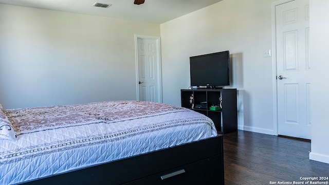 bedroom with ceiling fan and dark hardwood / wood-style floors