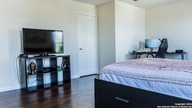 bedroom with dark hardwood / wood-style flooring