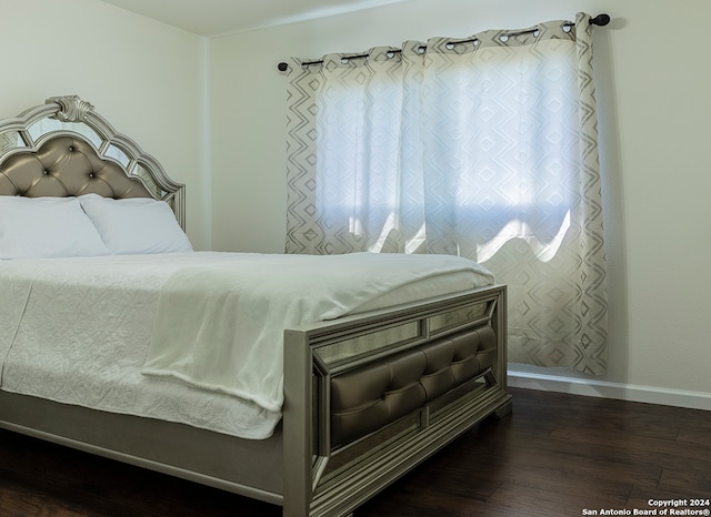 bedroom featuring dark wood-type flooring