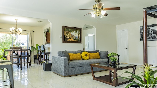 339 Cedron Chase, San Antonio, TX 78253 - living room with arched walkways, a ceiling fan, light tile patterned floors, and a chandelier