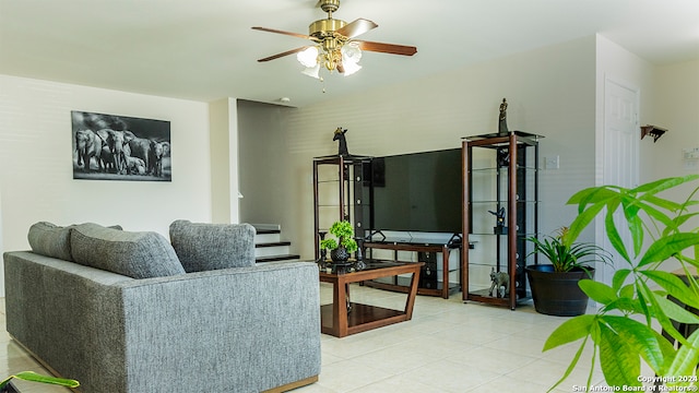 tiled living room with ceiling fan