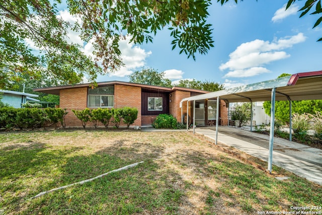 ranch-style house with a front lawn and a carport