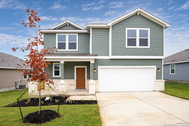 view of front of property featuring a lawn and a garage