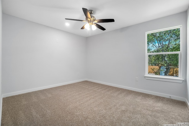 carpeted empty room featuring ceiling fan