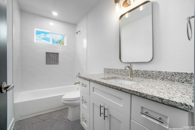 full bathroom featuring vanity, toilet, tile patterned floors, and tiled shower / bath