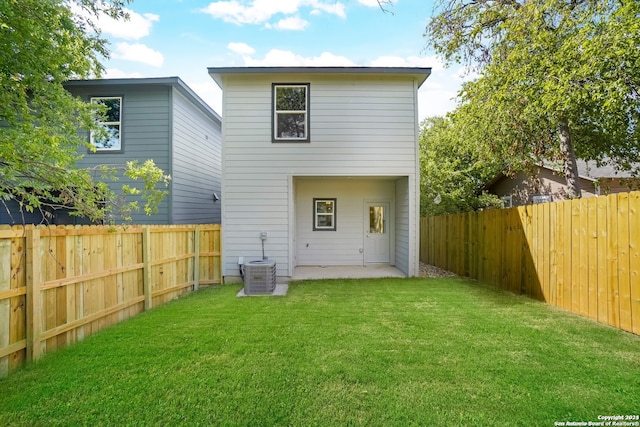 rear view of house featuring a yard, a patio area, and central AC