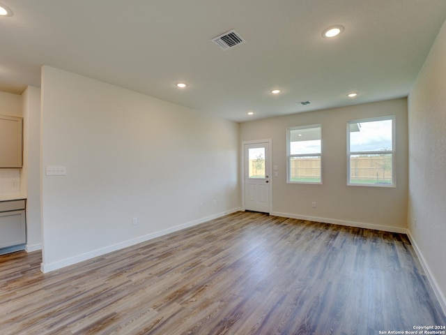 9918 Forestier Grn, San Antonio, TX 78221 - unfurnished living room with light wood-style flooring, recessed lighting, and baseboards
