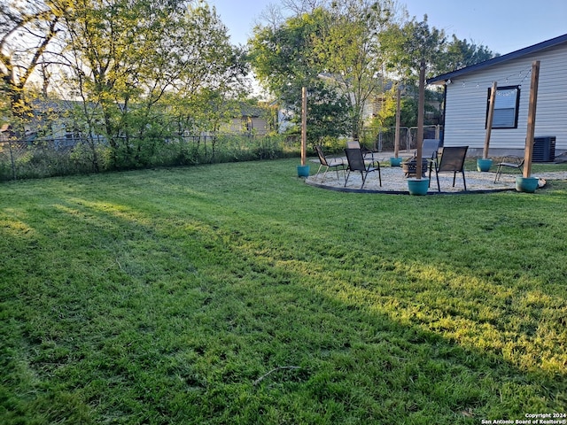 view of yard featuring central air condition unit and a patio area