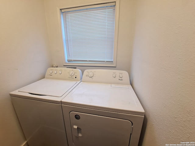 clothes washing area featuring washer and clothes dryer