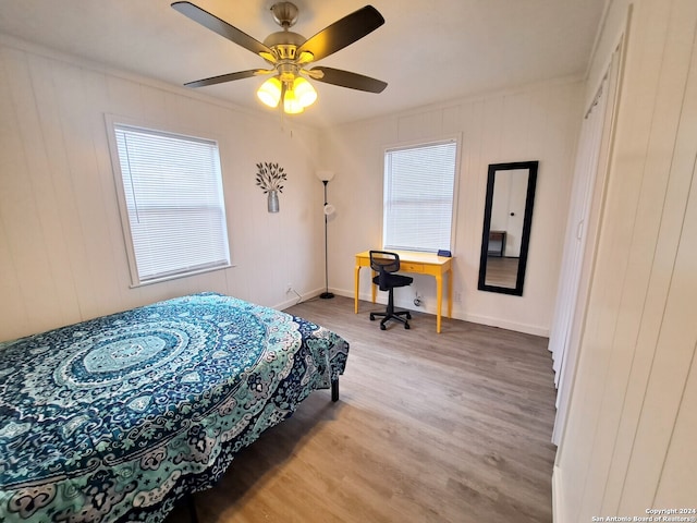 bedroom with ceiling fan and hardwood / wood-style flooring