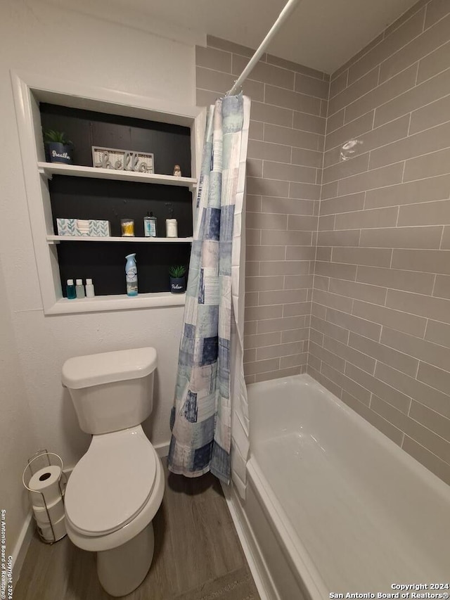 bathroom featuring shower / bath combination with curtain, hardwood / wood-style flooring, and toilet