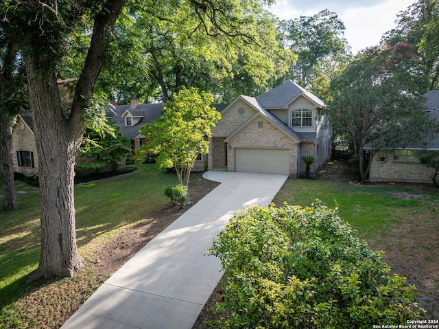 view of front of home featuring a garage and a front lawn