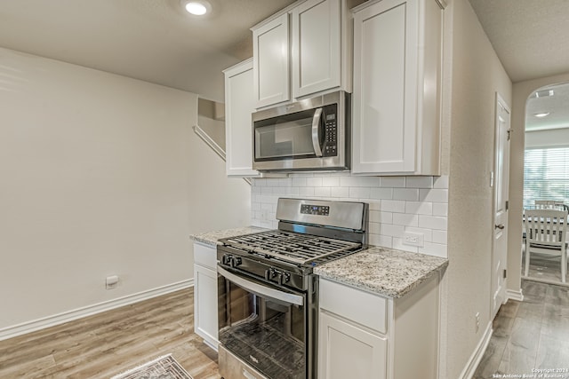 kitchen with appliances with stainless steel finishes and white cabinetry