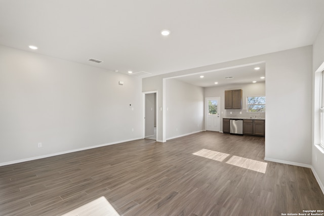 unfurnished living room with hardwood / wood-style floors and sink