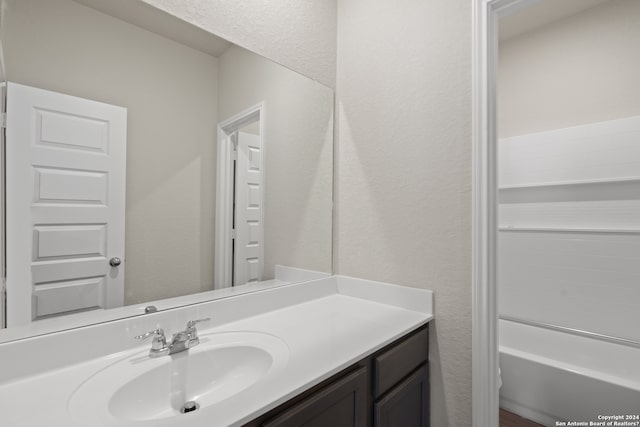 bathroom featuring a bath and vanity