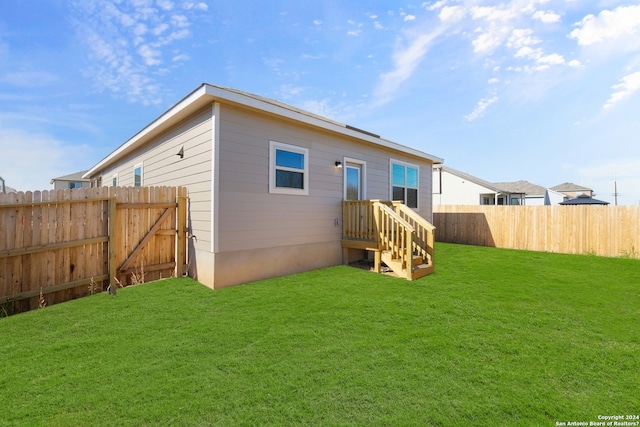 rear view of property with a lawn