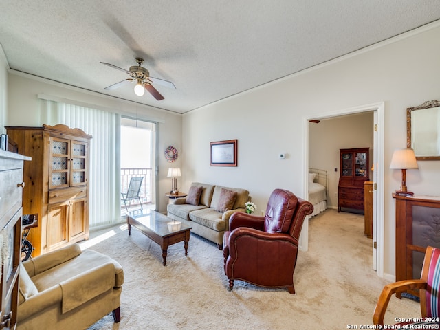 carpeted living room with ceiling fan, a textured ceiling, and ornamental molding