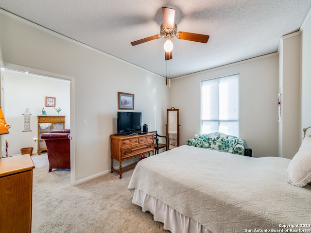 carpeted bedroom featuring ceiling fan and a textured ceiling