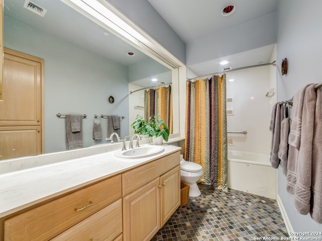 full bathroom featuring vanity, tile patterned floors, shower / tub combo, and toilet